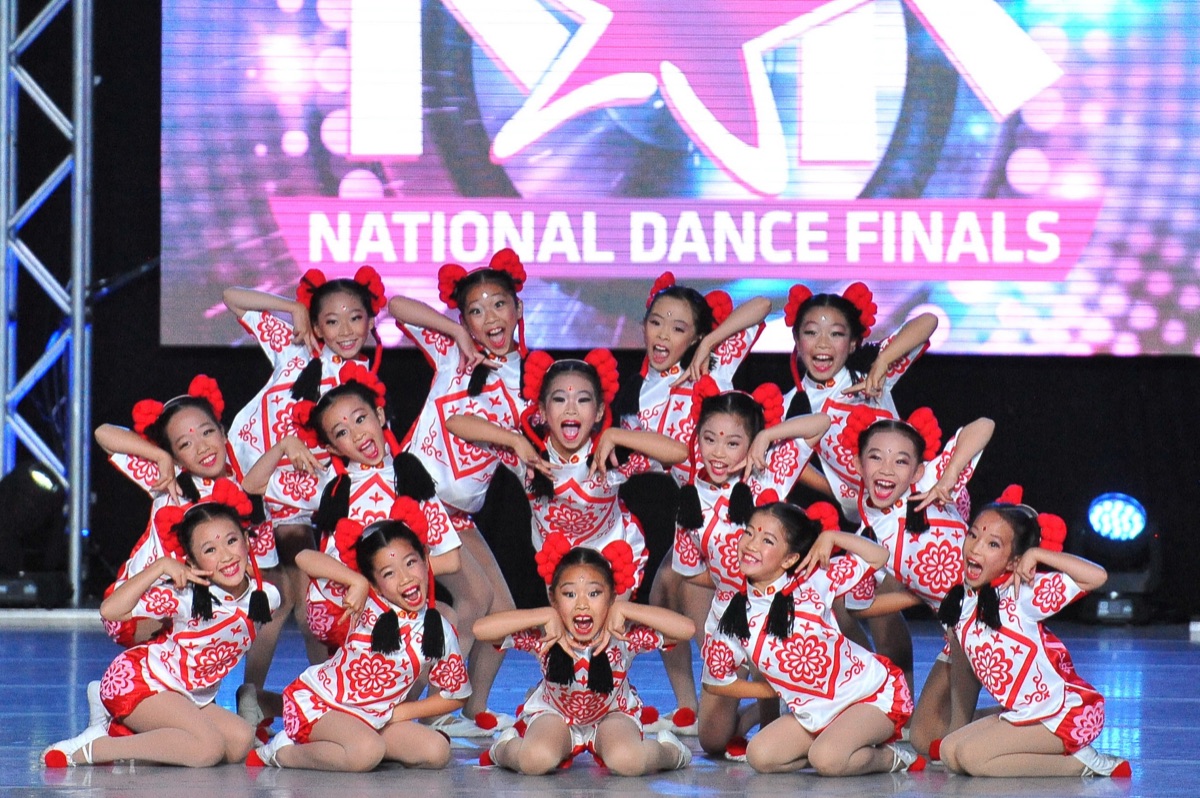 Young Jun Lu dancers in red and white costumes at the national dance finals