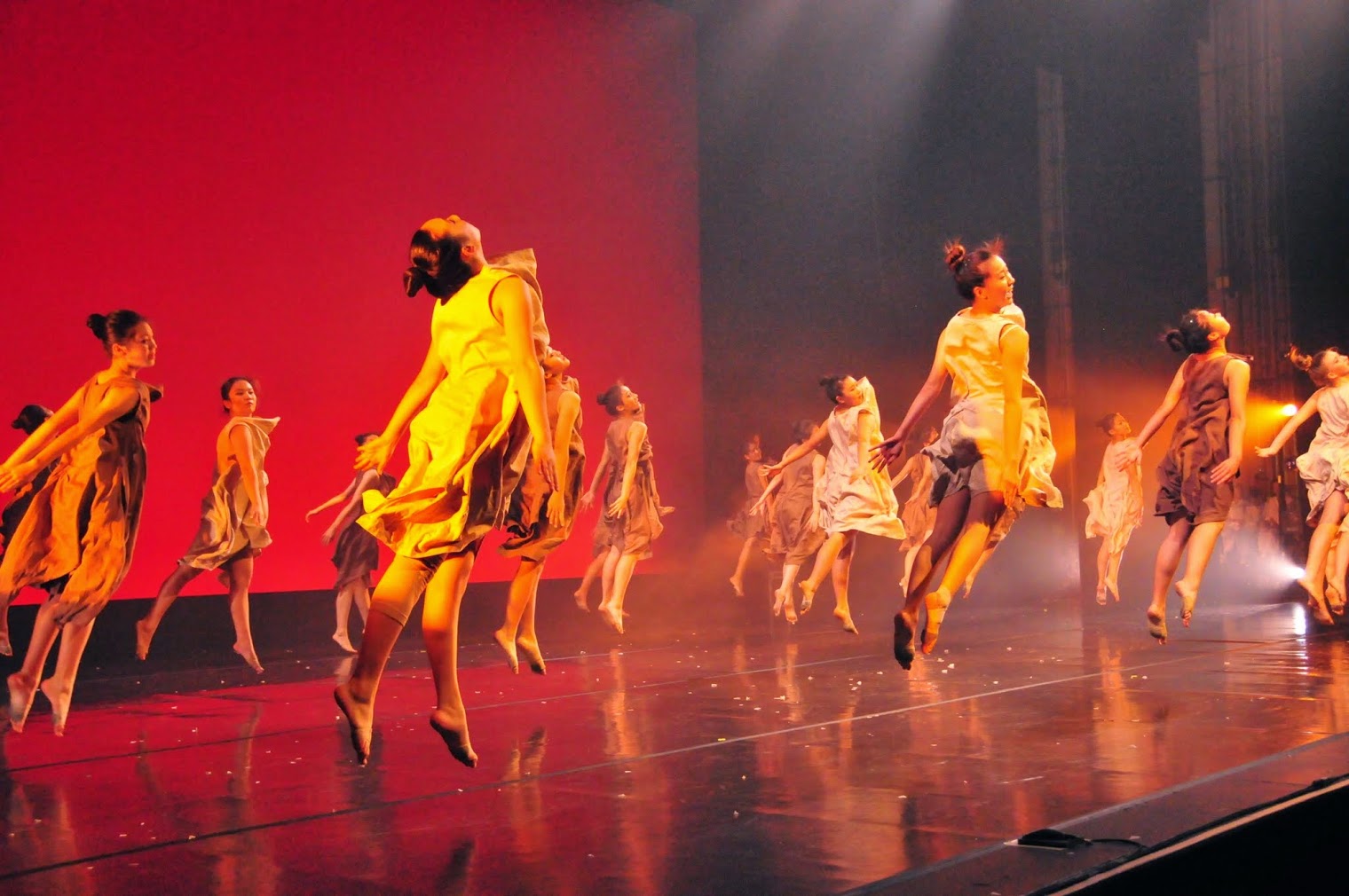 Jun Lu ensemble leaping together during a stage performance